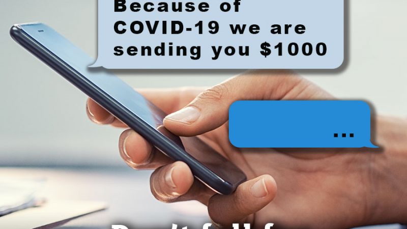 Person using a mobile phone with a message from an unkown sender reading, "Because of Covid-19 we are sending you $1000"