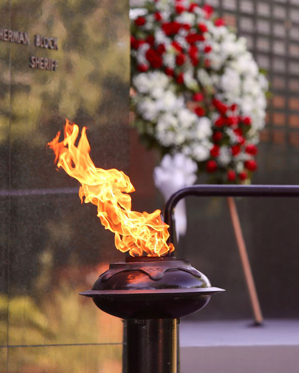 Ceremonial flame in front of the Memorial wall