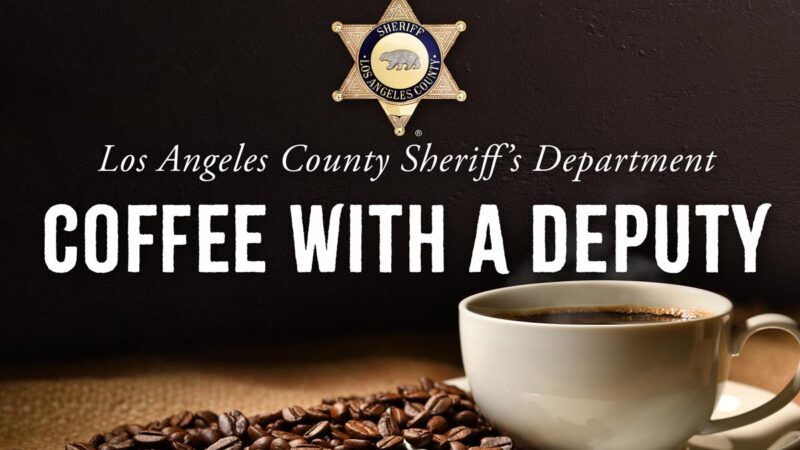 Image of a coffee cup on a plate, the plate is covered with coffee beans. Everything is sitting on a burlap material. At the top there is a Sheriff's star, gold six point star with an engraving of a bear in the middle. The text reads "Los Angeles County Sheriff's Department, Coffee with a Deputy"