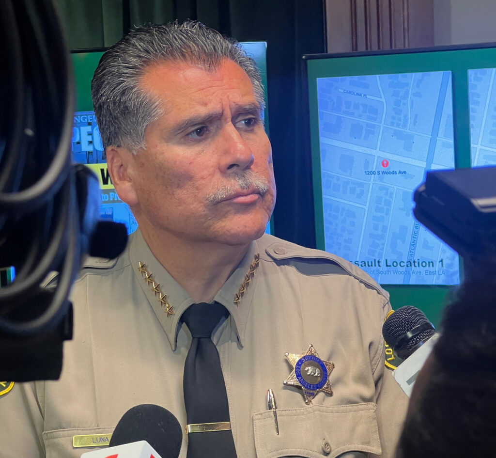 Sheriff Robert Luna Standing in uniform answering questions from media.