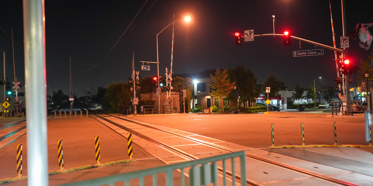 image of train track at night, One Street light is overhead.
