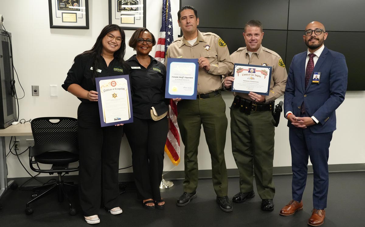 Two Deputies are holding Certificates of Recognition, with Three members of Irwindale City of Commerce.