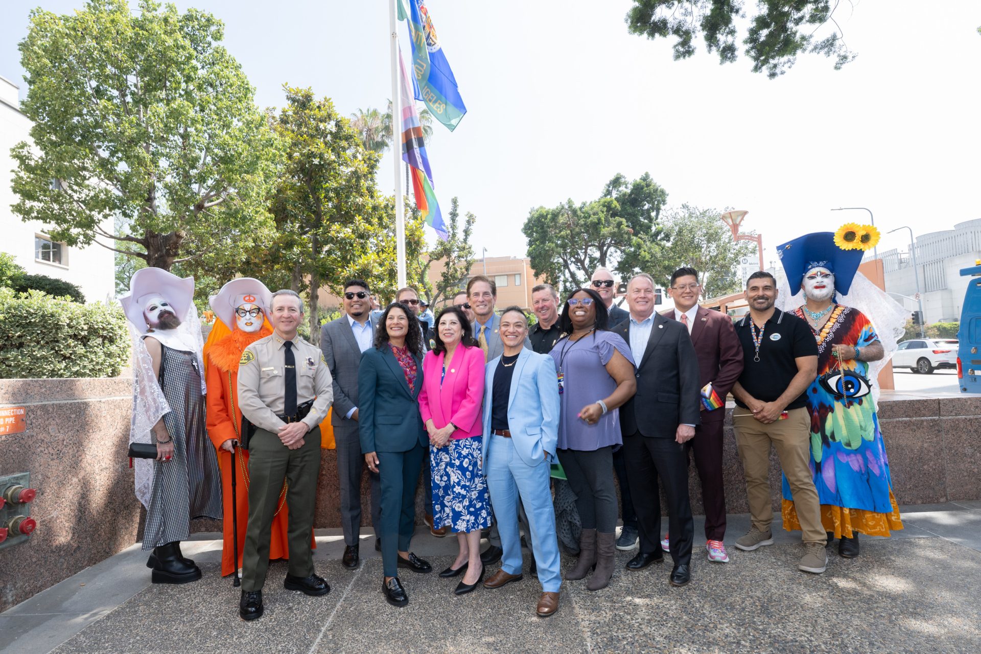 LA county representatives are posed next to the flag pole.